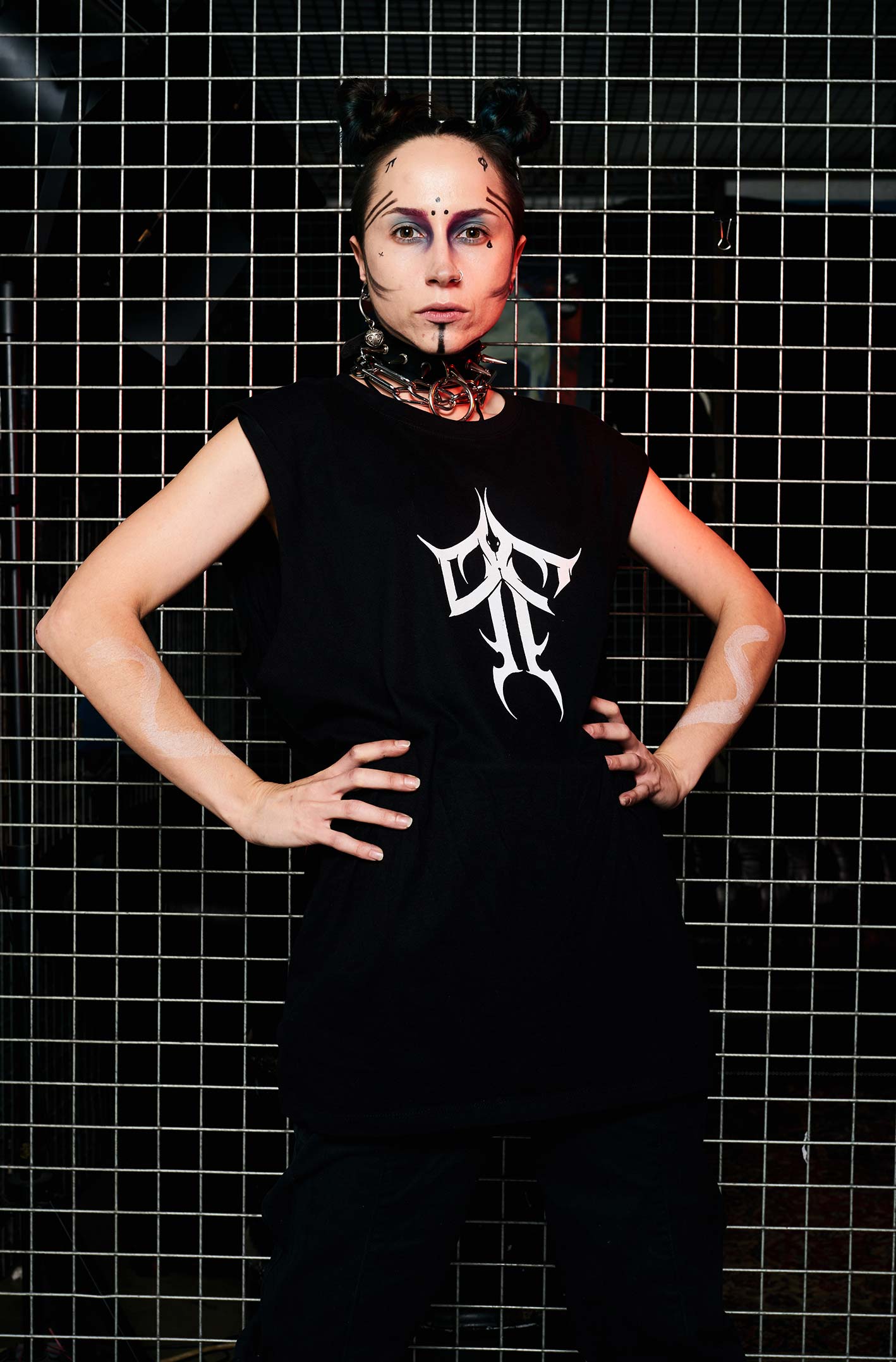 Tattooed woman wearing the HEX Paolo Ferrara Sleeveless T-shirt. P&F Typography on the chest, Paolo Ferrara's face on the back with a snake & red text. From HEX Venom collection.