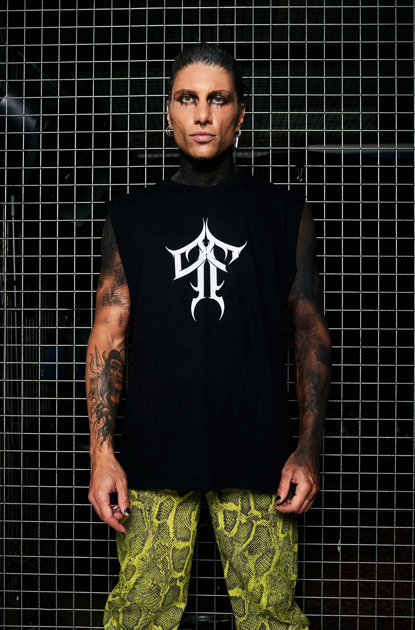 Paolo Ferrara wearing the HEX Paolo Ferrara Sleeveless T-shirt. P&F Typography on the chest, Paolo Ferrara's face on the back with a snake & red text. From HEX Venom collection.