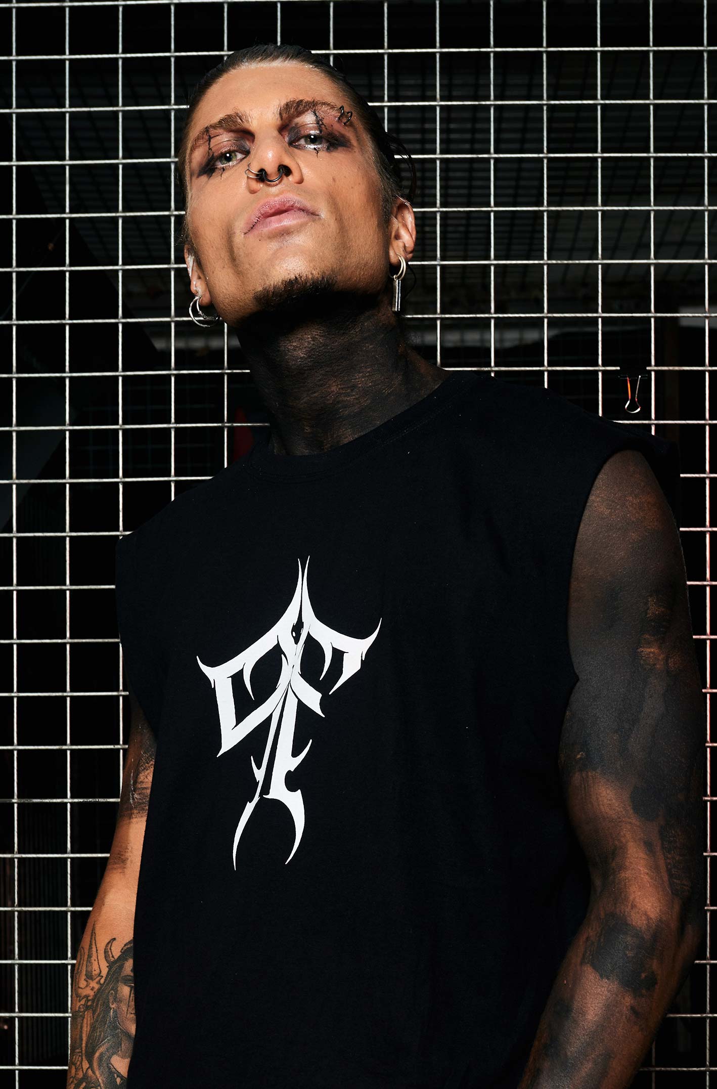 Paolo Ferrara wearing the HEX Paolo Ferrara Sleeveless T-shirt. P&F Typography on the chest, Paolo Ferrara's face on the back with a snake & red text. From HEX Venom collection.